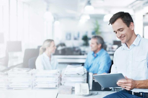 man in office looking at tablet